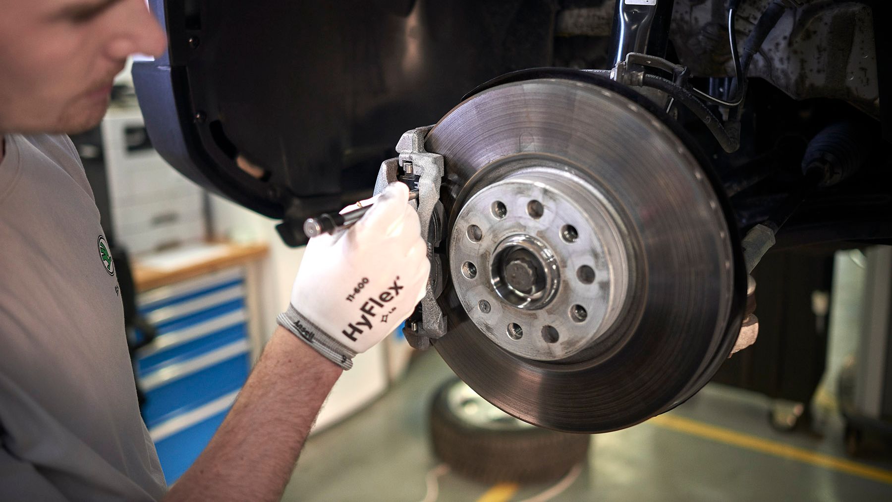 Skoda servicing team replacing brake disk