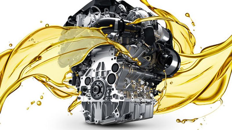 Silver car part with a splash of golden engine oil superimposed onto it