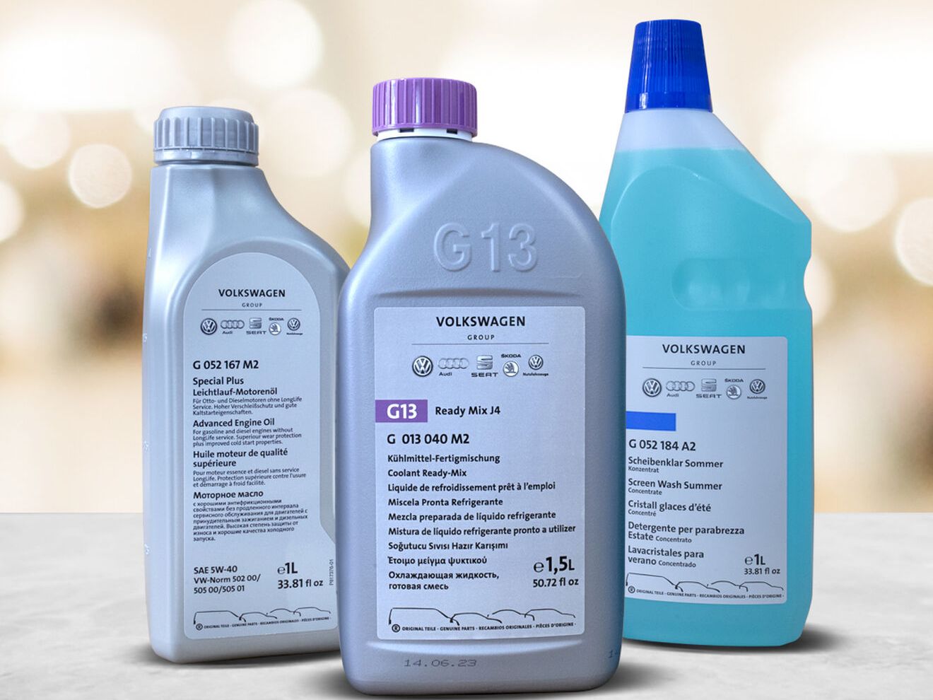Three bottles of the Ready-to-go package solution on a grey top with warm colored bokeh background